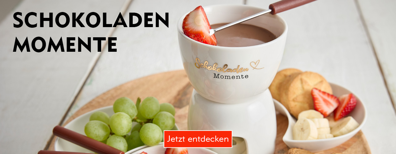 Shoppe Schokofondues und mehr bei Nanu-Nana Weißes Porzellan-Schokofondue mit der Aufschrift "Schokoladen Momente" verlinkt auf die Kategorie Kaffee, Schoko & Tee