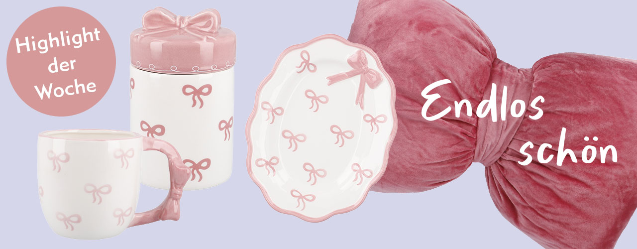 Becher, Teller und Dose mit rosa Schleifenmotiv und Schleifenkissen verlinkt auf Suche Schleife
