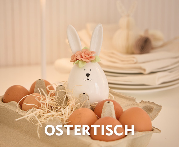 Keramik-Osterhase in einer Eierbox verlinkt auf die Kategorie Ostertisch