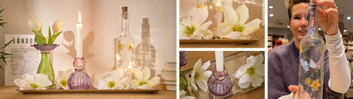 Fr&uuml;hlingsdeko mit LED-Flasche und Kerzenhaltern wird pr&auml;sentiert